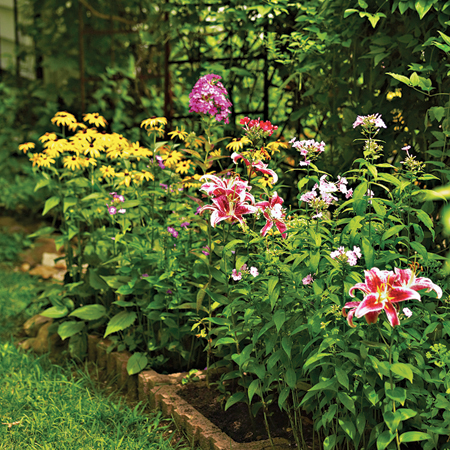 flower bed edged with leftover brick blocks
