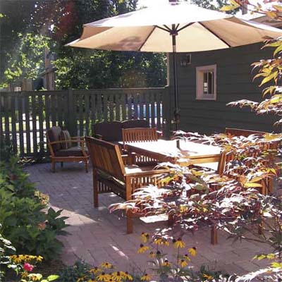 after photo of a back yard in Chicago, IL with stone patio and lush perennial garden