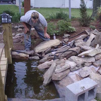 before photo of a back yard in Thurmond, MD with a developing pond on the side