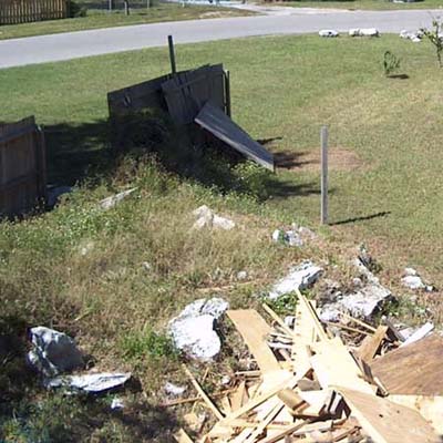 before photo of a back yard in Weeki Wachee, FL with a pile of debris in the foreground
