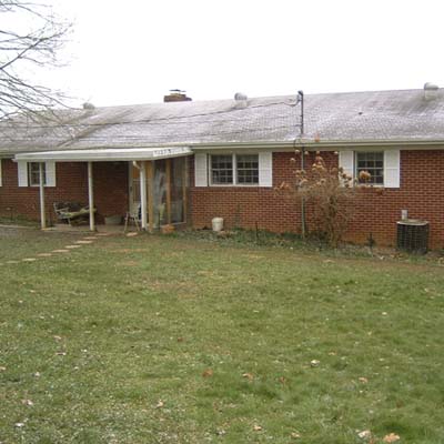 before photo of a back yard in Greeneville, TN with swampy, wet grass