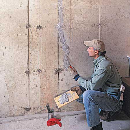 spreading sealer on the crack