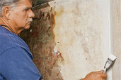 Tom Silva repairs a plaster wall