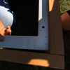 framing square against 2 attached 2x10 cedar boards to check for right angle