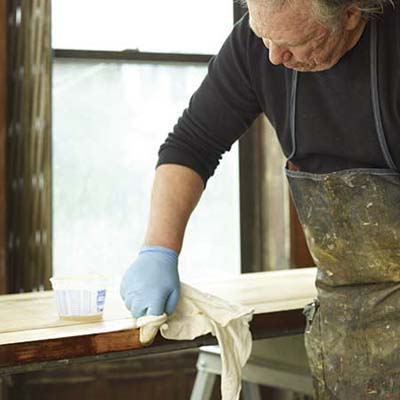 John Thomas tests the finish on the door edge