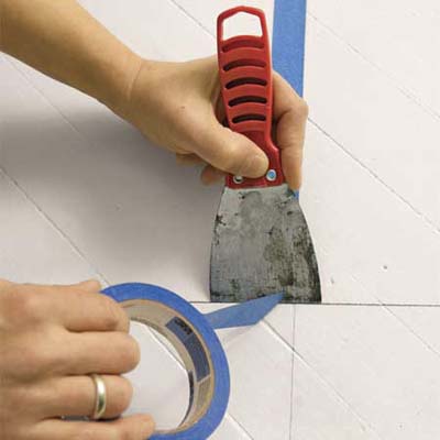 cutting painter's tape with a putty knife