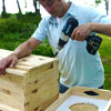 this old house editor mark powers using a drill driver to assemble the feed station box