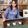 a woman attaching the top shelf on the brackets to make a vintage porcelain tap towel rack