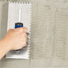 hand combing the scratch coat of a fireplace to create a stone veneer surround