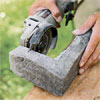 hand scoring the corner pieces of stone used to create a stone veneer surround