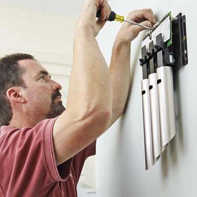 man replacing an electrical doorbell chime
