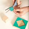cutting patterns out of craft foam to glue onto scrap wood blocks