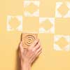 using a stamp on a yellow-painted wall