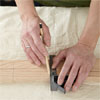 hands making the spindle locations for building a dog gate