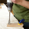 hands drilling one of the feet while building a dog gate