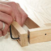 hands using an allen wrench to attach the feet while building a dog gate