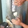 insulating the tank of a water heater with foil-covered bubble wrap