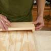 hands assembling fascia board and beadboard with caulk