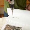 hands drilling wall organizer