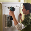 hands installing wall organizer to wall