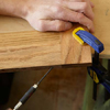 Mark Powers uses a drill/driver to put a pilot hole into the door frame of a dog crate