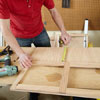 Mark Powers measures the side windows for a side panel of a dog crate