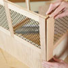 Mark Powers attaches a stile to a back panel of a dog crate