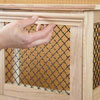 Mark Powers attaches trim to the top piece of a dog crate