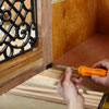 Mark Powers attaches the face frame to the rest of a dog crate