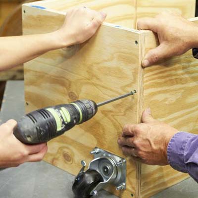 screwing the outer wall to the sides of the tool bench