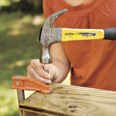 woman hammering nail