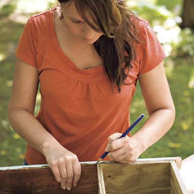 woman measuring window box frame
