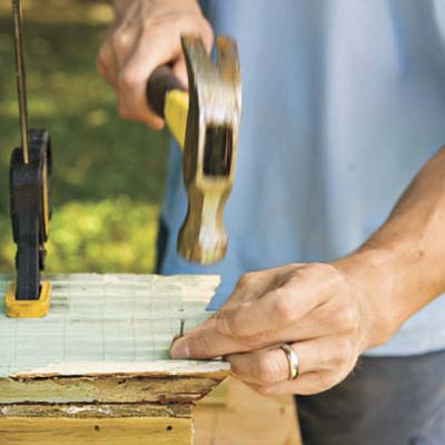 man using nail and hammer