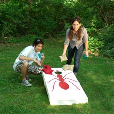 man and woman playing cornhole