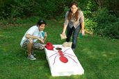 man and woman playing cornhole
