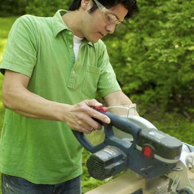 man using miter saw
