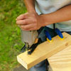 man making legs for cornhole game board
