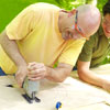 two men cutting out rings to make shishkaball game