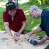 two men assembling stand for ladder golf