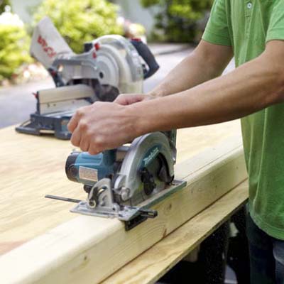 man using circular saw to cut four by four