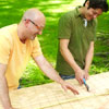 two men cutting wire to make shishkaball game
