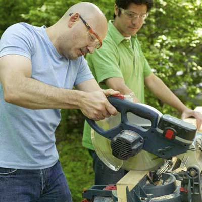 men using miter saw to cut kubb pieces