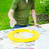man spray painting wood ring for shishkaball game