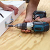two men attaching utility pulls for cornhole game board