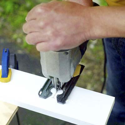 people cutting the slit for the elastic band while building a ricochet game board
