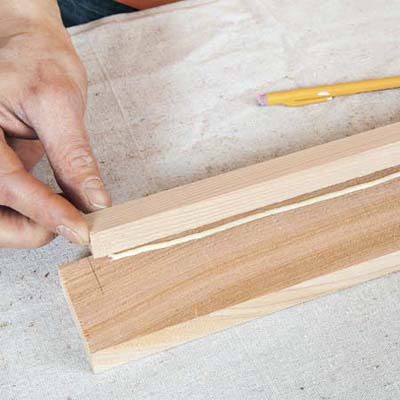 Mark Powers gluing ledges into a tray area for a bar cart