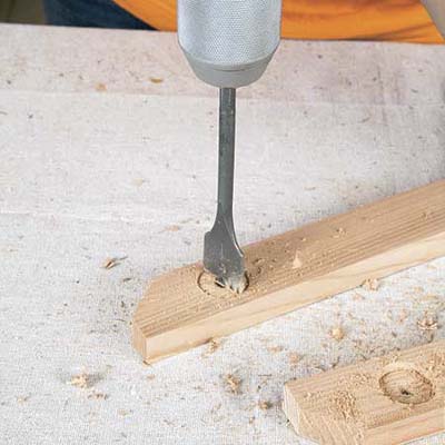 Mark Powers uses a 1-inch drill bit to make a countersink recess for the bar cart's handle