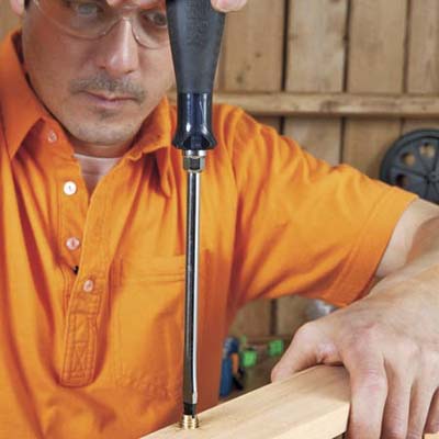 Mark Powers attaches the insert nuts for the sides of the bar cart