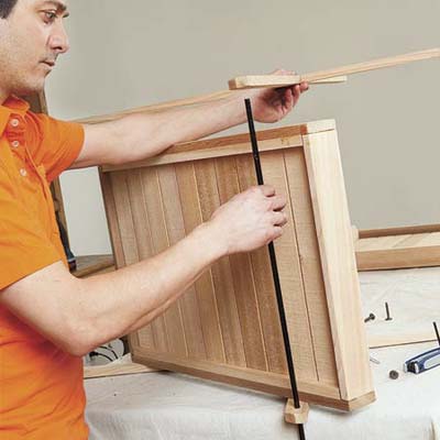 Mark Powers adds the axle to the bottom of the bar cart