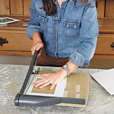 woman trims photo mat to size  